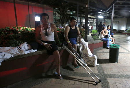 Patients wait outside a clinic that was evacuated after tremors were felt resulting from an earthquake in Ecuador, in Cali, Colombia, April 16, 2016. REUTERS/Jaime Saldarriaga