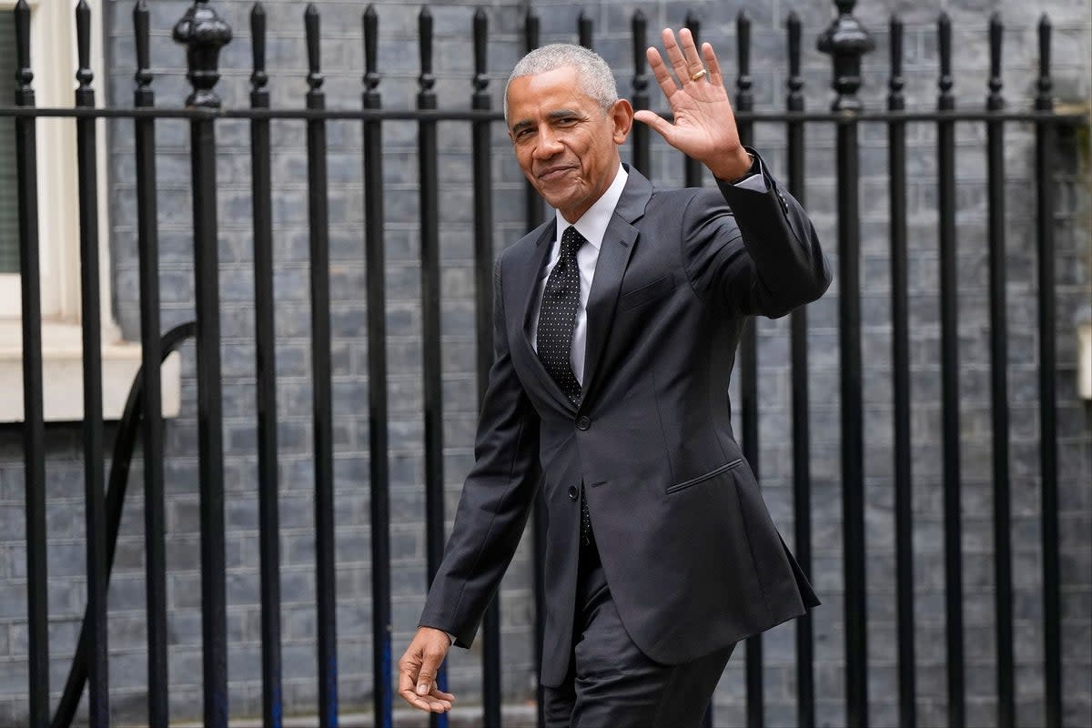 Former US President Barack Obama waves as he arrives for a courtesy visit to 10 Downing Street (AP)