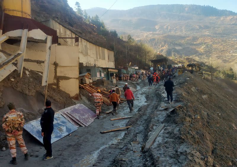 Rescue team members work outside a tunnel after a part of a glacier broke away and caused flood in Tapovan