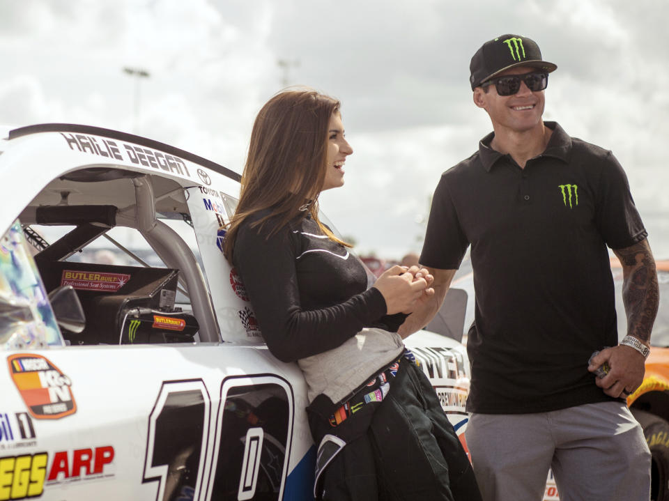 FILE - In this file image taken Feb. 11, 2018 and provided by Connexions Sports and Entertainment, NASCAR K&N Pro Series East driver Hailie Deegan shares a laugh with her father Brian Deegan at the New Smyrna Speedway in New Smyrna Beach Fla. On Saturday, Sept. 29, 2018, Seventeen-year-old Deegan used a bump-and-run on her teammate to become the first female winner of a NASCAR K&N West Series race. (Chris Garrison/Connexions Sports and Entertainment vis AP, File)