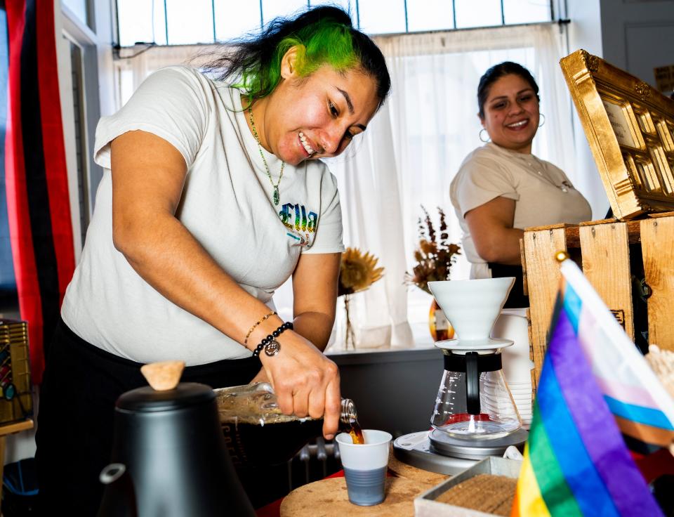 Reneé Valdez (left) and Sofía Fuentes (right) owner of Ellas Café prepare drinks at their pop up coffee shop stand at Materia Magicka, a community based art and metaphysical supply shop on Sunday February 12, 2023 in Milwaukee, Wis.