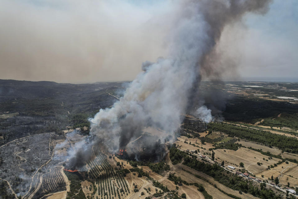 An aerial photo shows wildfires in Kacarlar village near the Mediterranean coastal town of Manavgat, Antalya, Turkey, Saturday, July 31, 2021. The death toll from wildfires raging in Turkey's Mediterranean towns rose to six Saturday after two forest workers were killed, the country's health minister said. Fires across Turkey since Wednesday burned down forests, encroaching on villages and tourist destinations and forcing people to evacuate. (AP Photo)