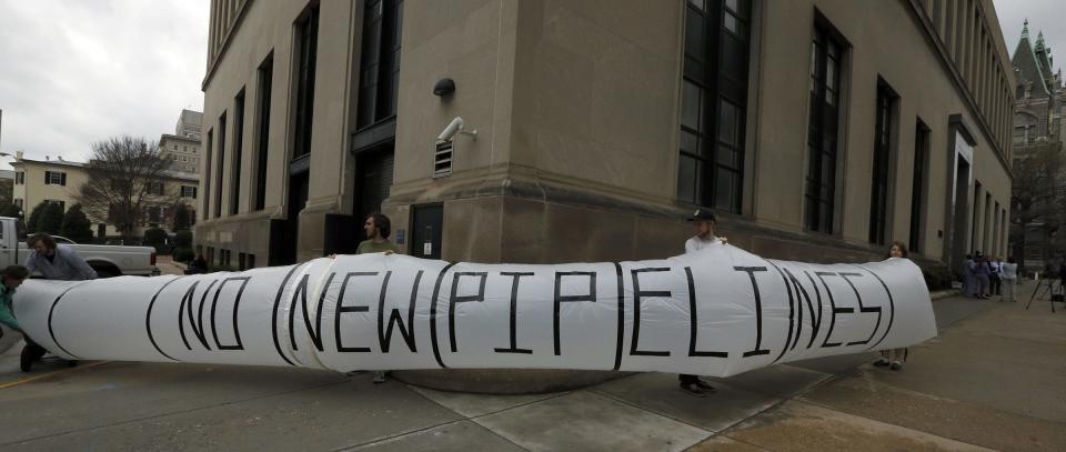 Protesters holding a "NO NEW PIPELINES" inflated "pipeline" in Richmond, Va., on April 7, 2015.