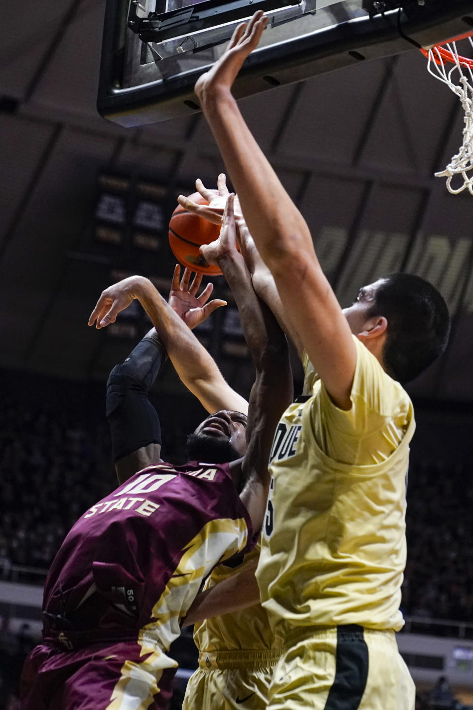 Florida State forward Malik Osborne (10) gets tied up with Purdue center Zach Edey (15) as they go for a rebound during the first half of an NCAA college basketball game in West Lafayette, Ind., Tuesday, Nov. 30, 2021. (AP Photo/Michael Conroy)