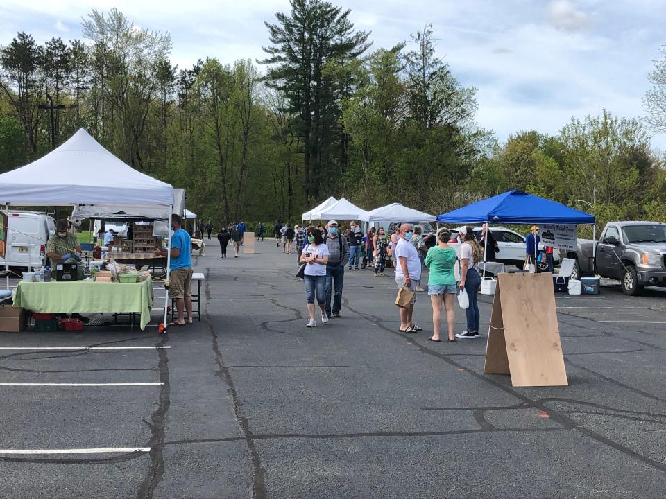 Guests check out various vendor booths at the Sparta Farmers Market Saturday, May 16, 2020.
