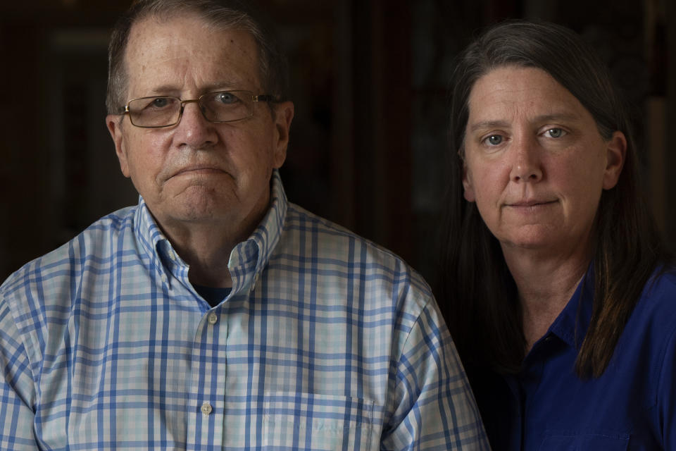 William Bortz, left, stands alongside his daughter, Ave Williams, at his senior living center, Friday, May 17, 2024, in San Diego. Bortz said criminals stole his family's nest egg of almost $700,000 in an elaborate scheme. Sophisticated overseas criminals are stealing tens of billions of dollars from Americans every year, a crime wave that's projected to get worse as the U.S. population ages and technology like AI makes it easier than ever to perpetrate fraud and get away with it. (AP Photo/Gregory Bull)