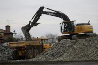 Rocks are loaded onto trucks as part of the efforts to repair the Oroville Dam Wednesday, Feb. 15, 2017, in Oroville, Calif. The Oroville Reservoir is continuing to drain Wednesday as state water officials scrambled to reduce the lake's level ahead of impending storms. (AP Photo/Marcio Jose Sanchez)