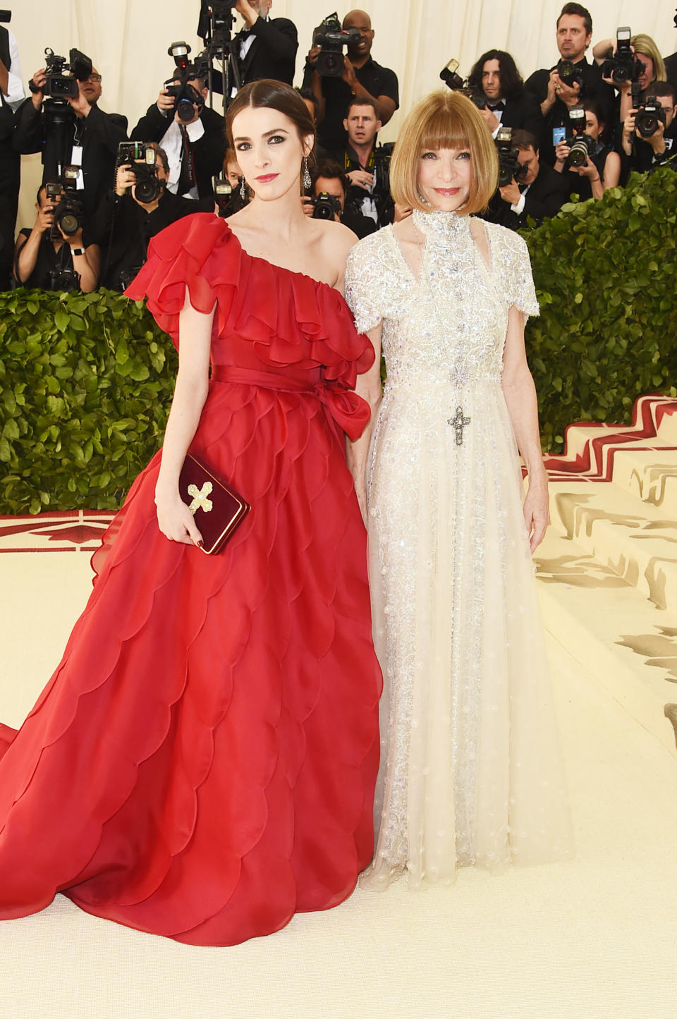 <p>Anna Wintour and her daughter Bee Schaffer were some of the first people to arrive on the red carpet. Anna looks right on theme in this high collared lace beaded gown from Chanel, while Bee matched the carpet in a billowing red number. Photo: Getty Images </p>