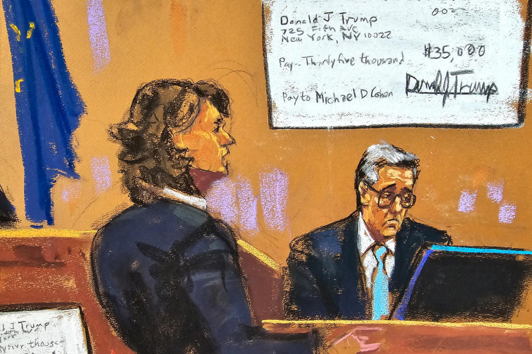 Cohen is questioned by prosecutor Susan Hoffinger while a reimbursement check is shown on a screen during Trump's criminal hush money trial on Tuesday. 