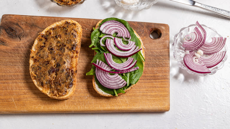 Two slices of bread with dates spinach and onion