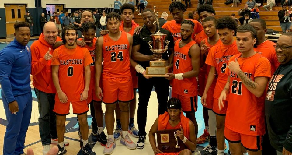 Coach Marquis Webb (center) and Eastside celebrate winning the title at the 52nd Passaic County boys basketball tournament at Wayne Valley on Saturday, February 18, 2023.