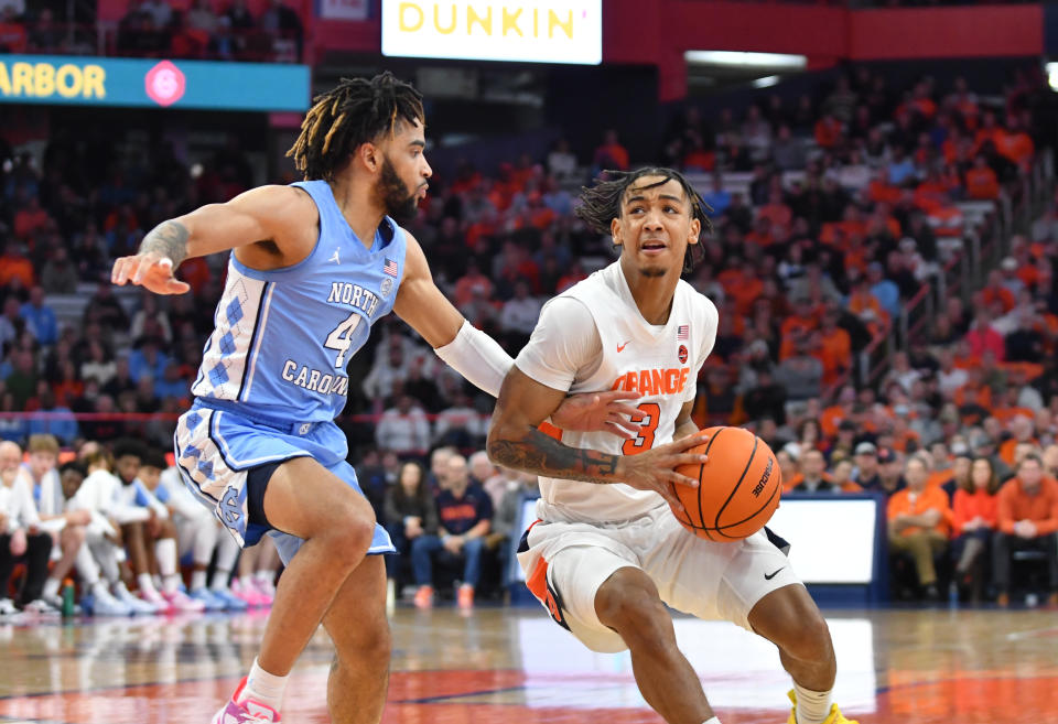 Jan 24, 2023; Syracuse, New York, USA; Syracuse Orange guard Judah Mintz (3) looks to the basket as North Carolina Tar Heels guard R.J. Davis (4) defends in the second half at JMA Wireless Dome. Mandatory Credit: Mark Konezny-USA TODAY Sports