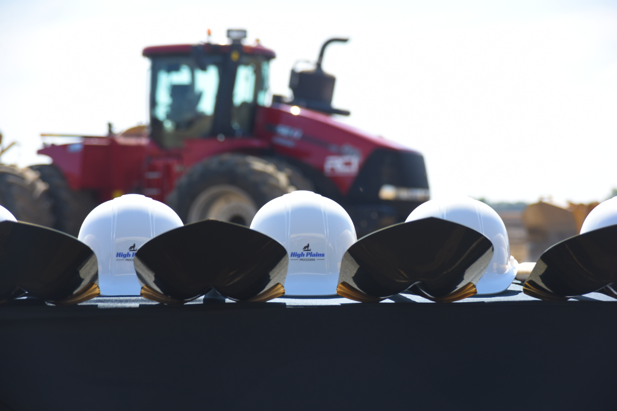 Golden shovels and hard hats are lined up on a table at the future site of High Plains Processing, LLC's multi-seed processing facility south of Mitchell on Tuesday, Sept. 19, 2023. High Plains Processing, a subsidiary of South Dakota Soybean Processors, held a groundbreaking ceremony to mark the first day of construction for the plant.