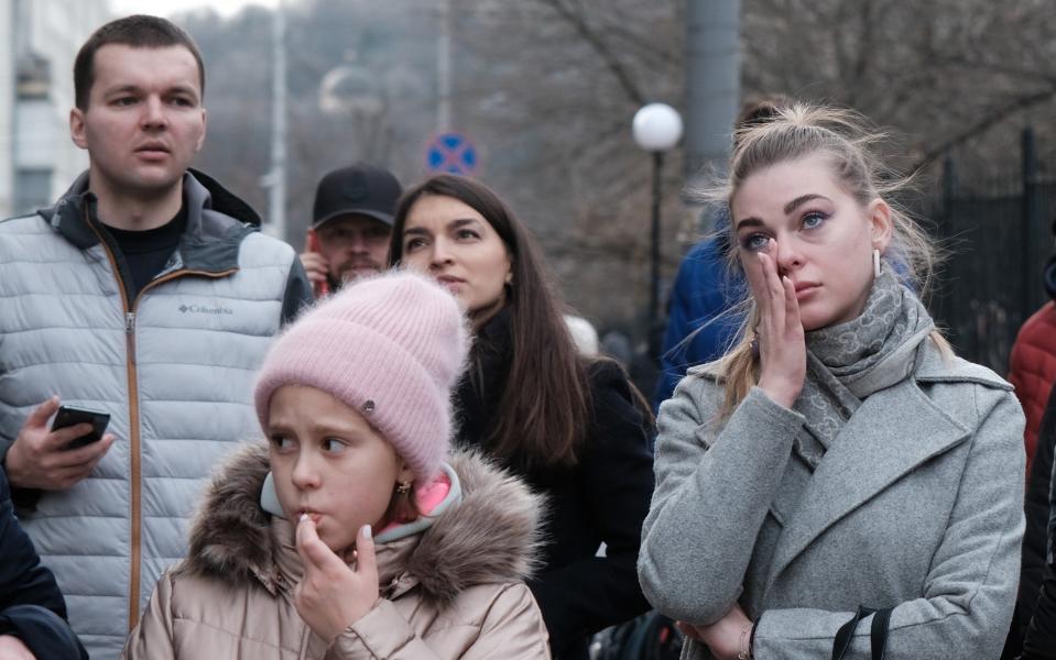 Kyiv residents look at a destroyed building that was struck by a Russian missile on New Year's Day - Spencer Platt/Getty