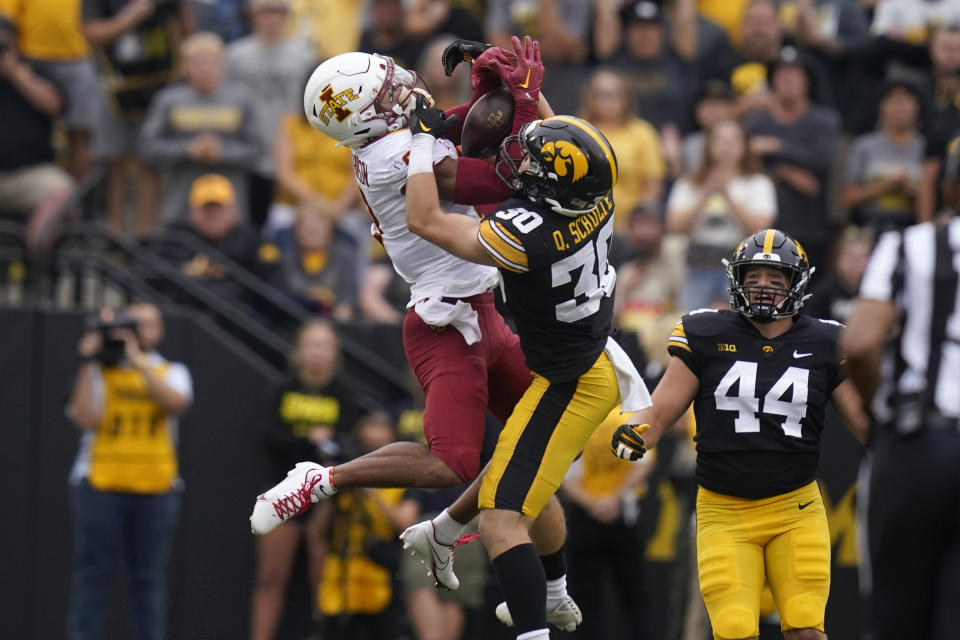 Iowa State wide receiver Xavier Hutchinson, left, catches a pass over Iowa defensive back Quinn Schulte (30) during the first half of an NCAA college football game, Saturday, Sept. 10, 2022, in Iowa City, Iowa. (AP Photo/Charlie Neibergall)