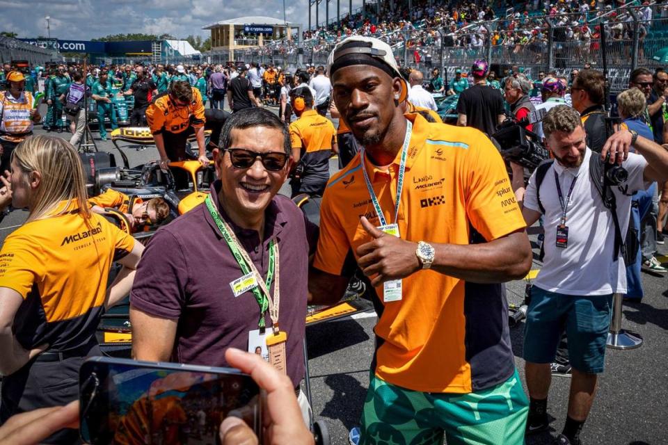 Miami Heat forward Jimmy Butler, right, poses for a picture with a fan on the grid before the start of the Sprint race.