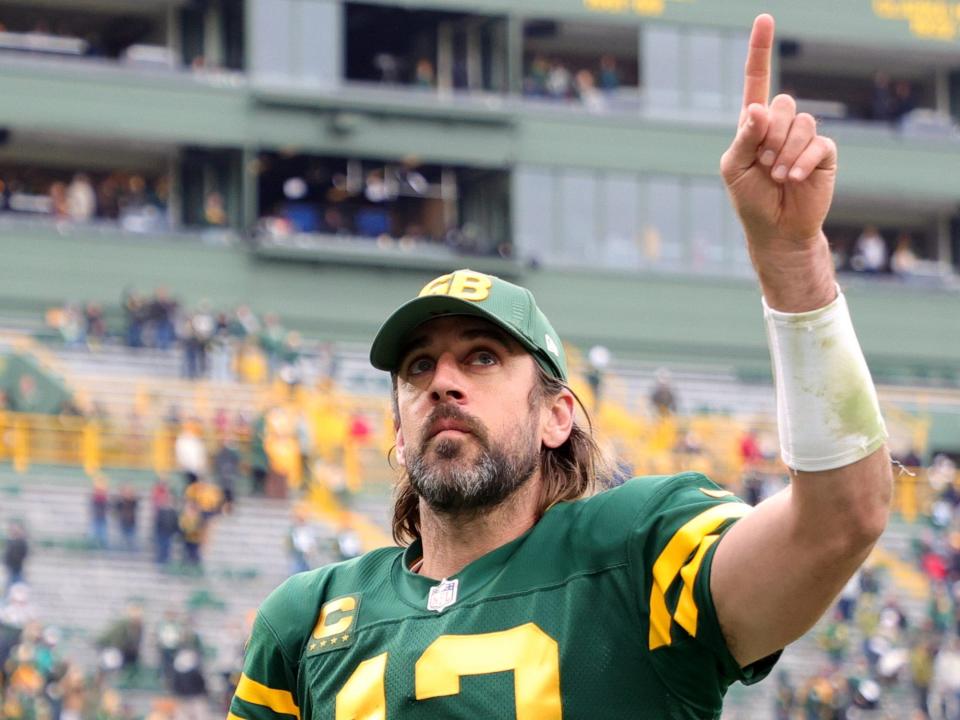 aaron rodgers pointing at himself and throwing a #1 symbol in the air