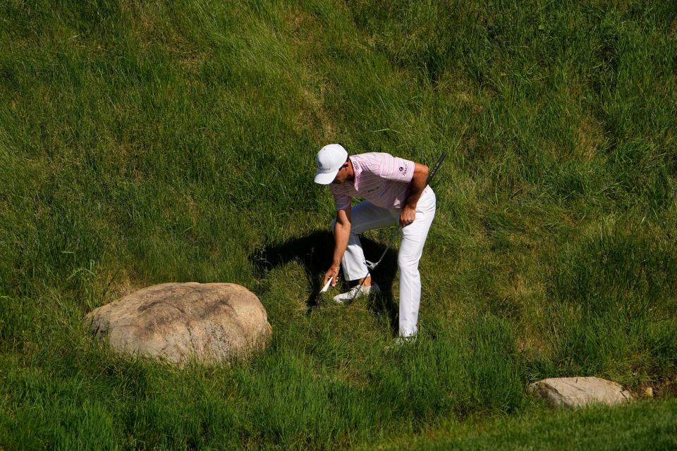 Jun 4, 2022;  Dublin, Ohio, USA;  Billy Horschel marks the ball of Luke List that lodged itself in the hill below the 17th green during the third round of the Memorial Tournament at Muirfield Village Golf Club.  Mandatory Credit: Adam Cairns-The Columbus Dispatch