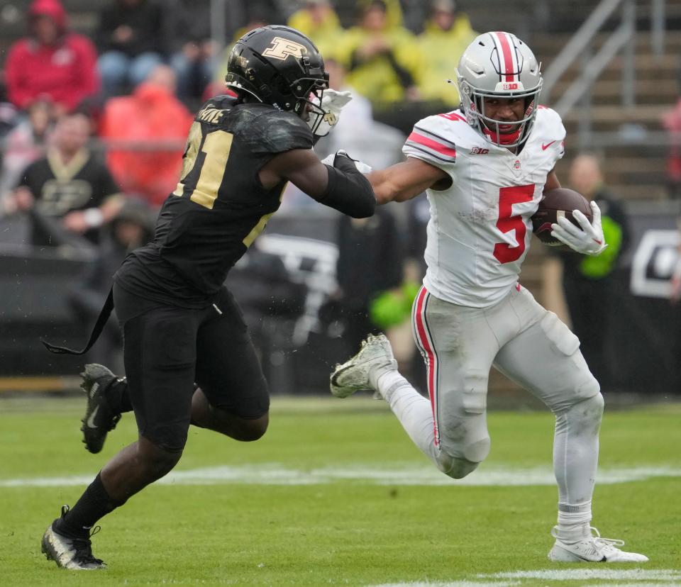 Oct. 14, 2023; Lafayette, In., USA; 
Ohio State Buckeyes running back Dallan Hayden (5) is pursued by Purdue Boilermakers defensive back Sanoussi Kane (21) during the second half of Saturday's NCAA Division I football game at Ross-Ade Stadium in Lafayette.