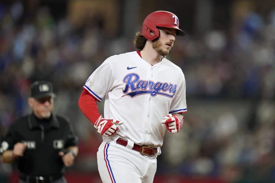 Texas Rangers' Jonah Heim rounds the bases after hitting a solo home run in the fifth inning of a baseball game against the Philadelphia Phillies, Tuesday, June 21, 2022, in Arlington, Texas. (AP Photo/Tony Gutierrez)