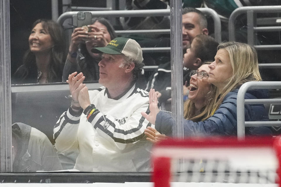 Actor Will Ferrell, left, applauds during the second period of an NHL hockey game between the Anaheim Ducks and the Los Angeles Kings Tuesday, Dec. 20, 2022, in Los Angeles. (AP Photo/Ashley Landis)