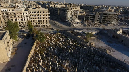 A still image taken on September 27, 2016 from a drone footage obtained by Reuters shows a cemetery surrounded by damaged buildings in a rebel-held area of Aleppo, Syria. Handout via Reuters TV