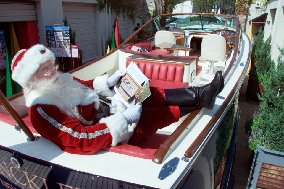 Brady White, Michael J. Chellel's stage name, poses in a Hinckley T29 R powerboat during a media preview of the Neiman Marcus Christmas Book in September 2002 in Dallas.