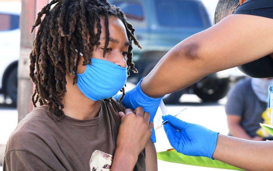 Jacob Alexander, 14, receives a Pfizer Covid-19 vaccination in Los Angeles, US on 16 July 2021  - Frederic J Brown/AFP