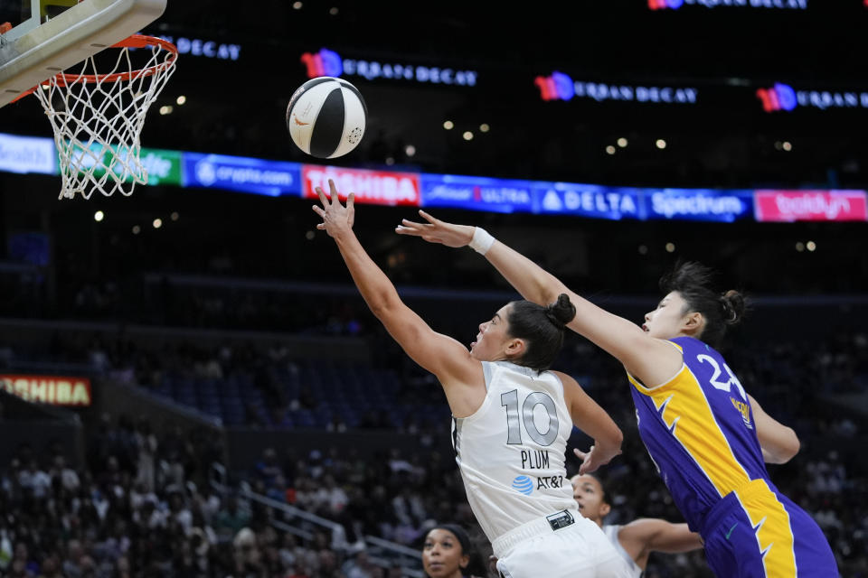 Las Vegas Aces guard Kelsey Plum, left, scores past Los Angeles Sparks center Li Yueru during the first half of a WNBA basketball game, Sunday, June 9, 2024, in Los Angeles. (AP Photo/Ryan Sun)