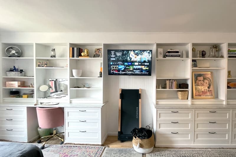 White shelving and drawers line wall, replacing etageres and various shelving pieces.