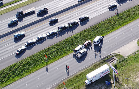 Law enforcement and fire personnel attend the scene where a serial bombing suspect died at the side of the highway near Round Rock, north of Austin, Texas, U.S. March 21, 2018, REUTERS/DroneBase