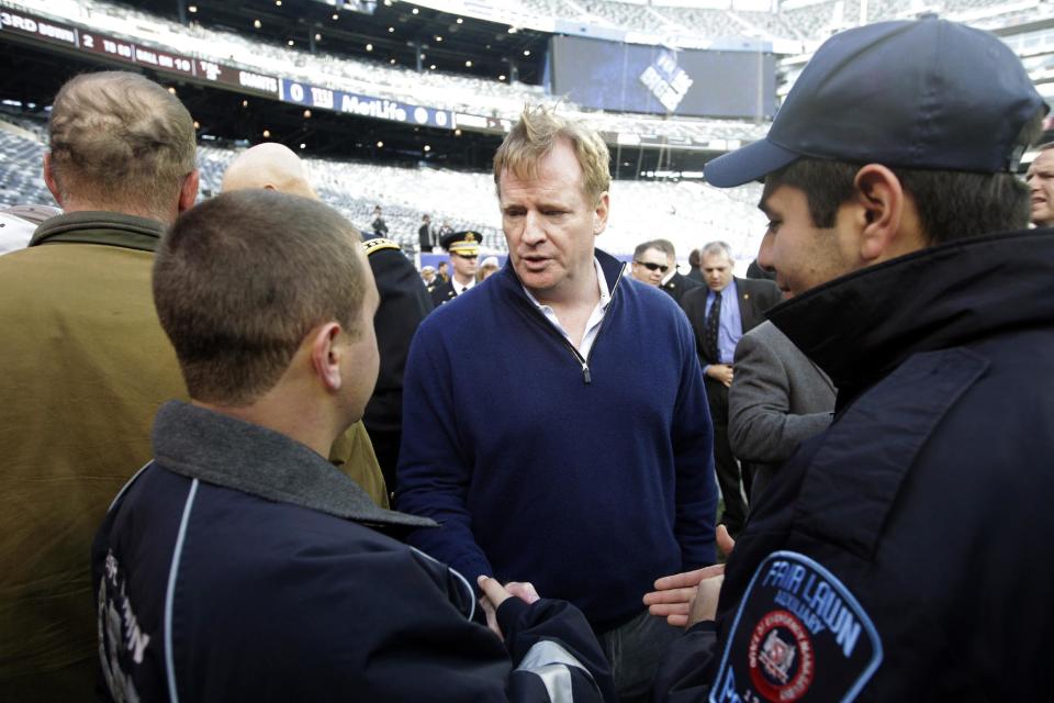 Superstorm Sandy first responders Geovanny Buitron, right, and Steve Shore, left, talk to NFL Commissioner Roger Goodell before a football game between the New York Giants and the Pittsburgh Steelers, Sunday, Nov. 4, 2012, in East Rutherford, N.J. (AP Photo/Frank Franklin II)