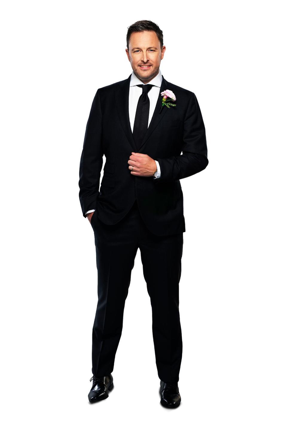 New groom Matt in his dark suit and tie on Married At First Sight 2022. He has dark hair and facial hair.