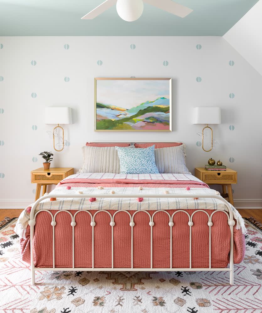 a bed with a pink and white bed spread