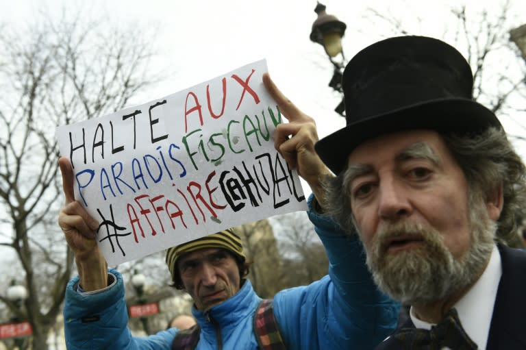 Protesters demonstrate against the impunity of the banking system as French budget minister Jerome Cahuzac goes on trial in Paris on February 8, 2016