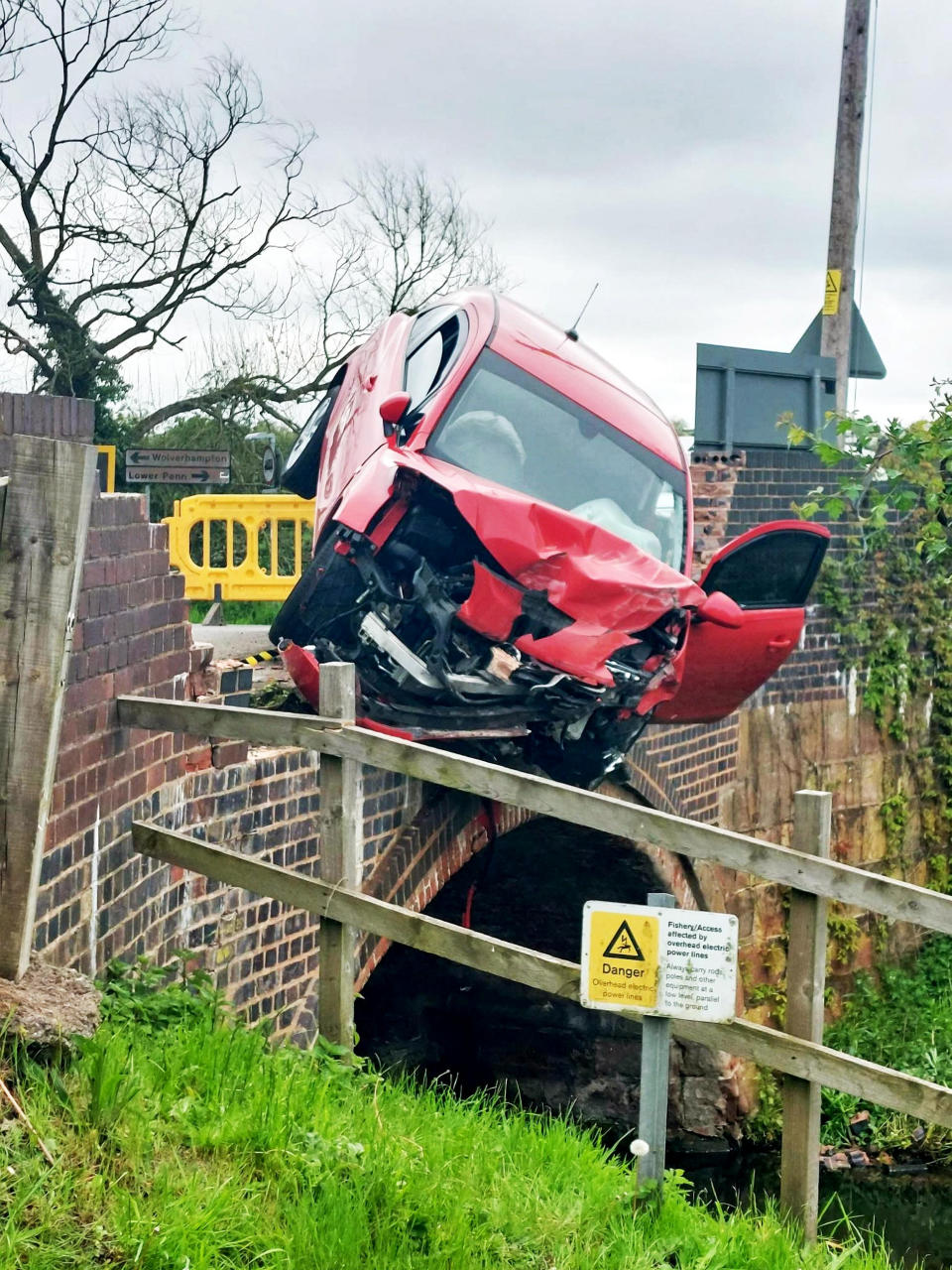 Police had to seal the road off to the public while specialist teams worked to recover the precariously wedged car. (SWNS)