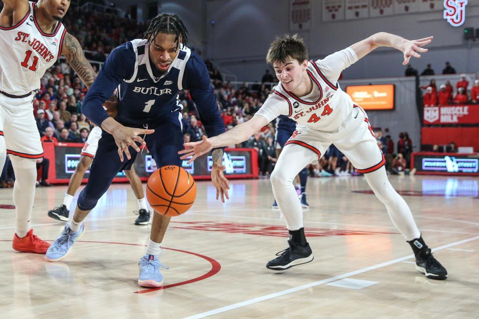 Jan 2, 2024; Queens, New York, USA; Butler Bulldogs forward Jalen Thomas (1) and St. John's Red Storm forward Brady Dunlap (44) fight for a loose ball in the first half at Carnesecca Arena. Mandatory Credit: Wendell Cruz-USA TODAY Sports