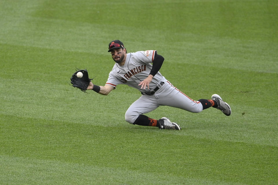 San Francisco Giants left fielder Mike Tauchman makes a catch on a line drive by Washington Nationals' Trea Turner for an out during the eighth inning of a baseball game, Sunday, June 13, 2021, in Washington. (AP Photo/Nick Wass)