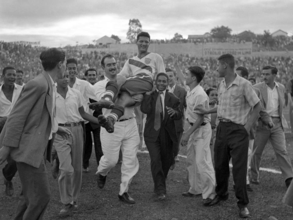 FILE - U.S. center forward Joe Gaetjens is carried off by cheering fans after his team beat England 1-0 in a World Cup soccer match in Belo Horizonte, Brazil on June 28, 1950. (AP Photo/File)