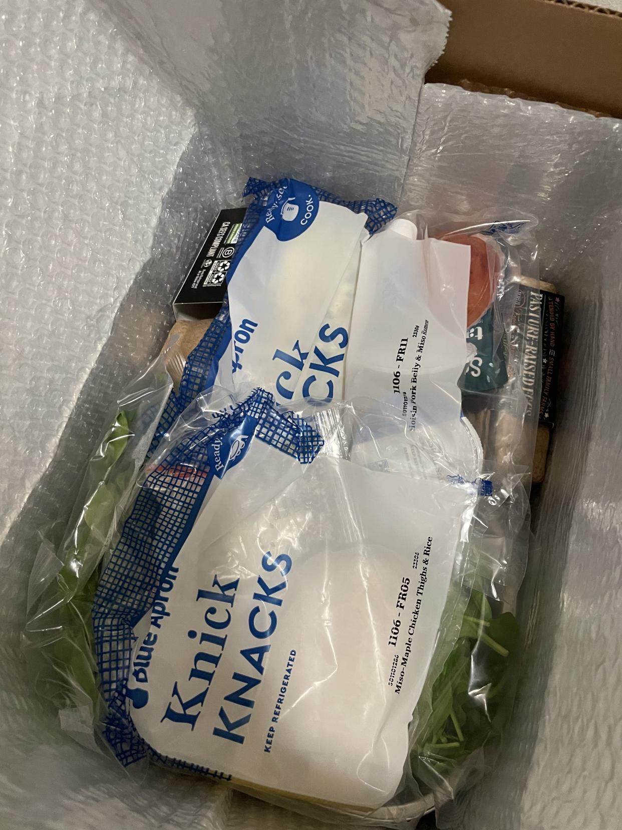 Open box with plastic bags full of ingredients