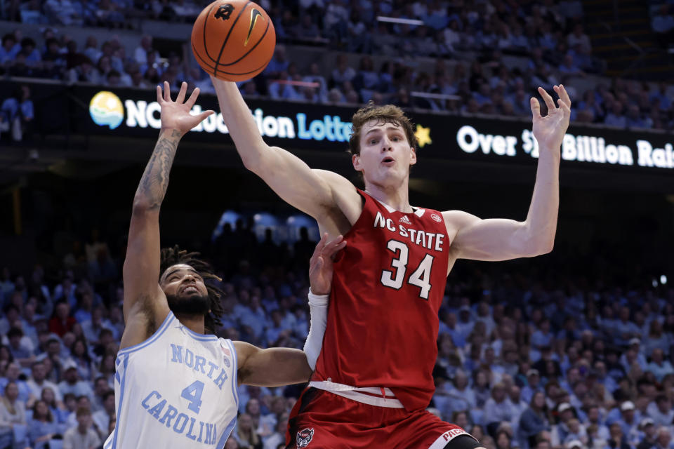 North Carolina State forward Ben Middlebrooks (34) and North Carolina guard RJ Davis (4) go for the ball during the second half of an NCAA college basketball game Saturday, March. 2, 2024, in Chapel Hill, N.C. (AP Photo/Chris Seward)