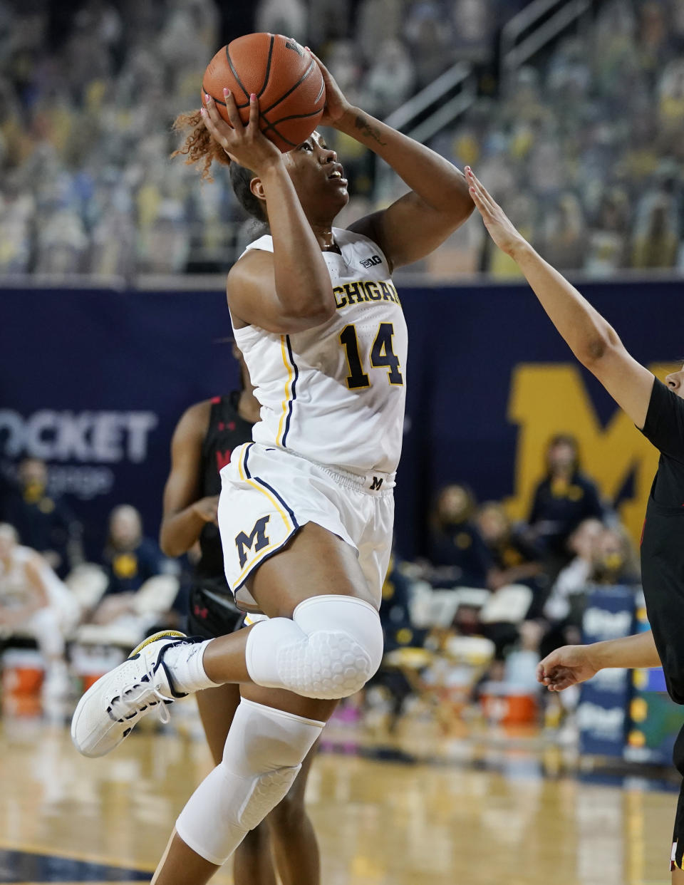 Michigan guard Akienreh Johnson (14) attempts a shot during the first half of an NCAA college basketball game against Maryland, Thursday, March 4, 2021, in Ann Arbor, Mich. (AP Photo/Carlos Osorio)