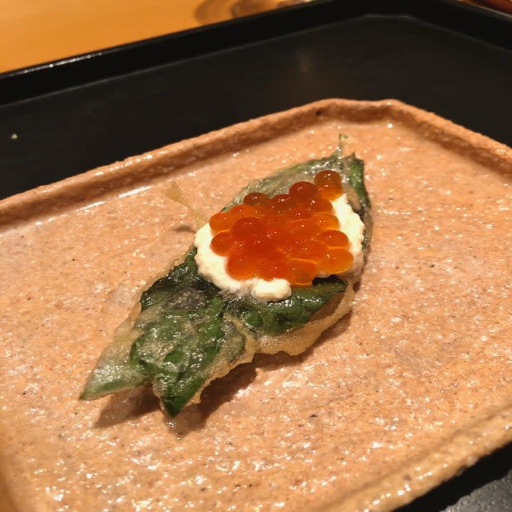 A fried shisho leaf with salmon roe