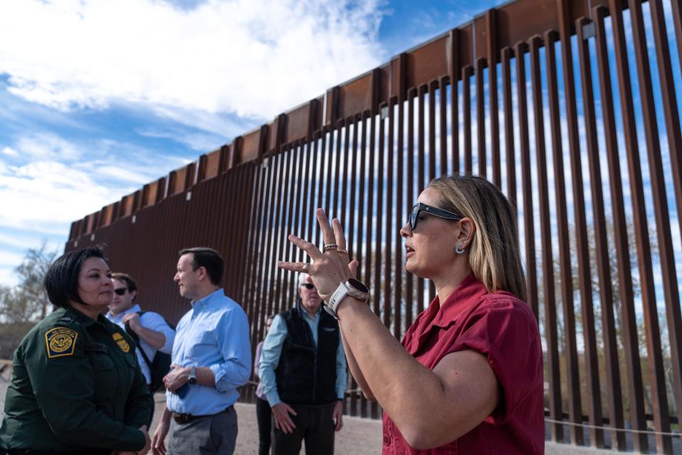 U.S. Senator Kyrsten Sinema, I-Ariz., right, visits the U.S.-Mexico border in Somerton, Ariz., near the Cocopah Indian Reservation boundary on January 10, 2023.