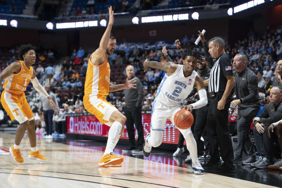 Nov 21, 2021; Uncasville, CT, USA; North Carolina Tarheels guard Caleb Love (2) dribbles the ball past <a class="link " href="https://sports.yahoo.com/ncaaw/teams/tennessee/" data-i13n="sec:content-canvas;subsec:anchor_text;elm:context_link" data-ylk="slk:Tennessee Volunteers;sec:content-canvas;subsec:anchor_text;elm:context_link;itc:0">Tennessee Volunteers</a> forward Uros Plavsic (33) defending during the first half at Mohegan Sun Arena. Gregory Fisher-USA TODAY Sports