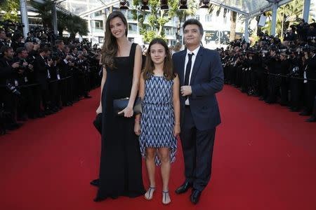 Producer Thomas Langmann (R) and his wife journalist Celine Bosquet pose on the red carpet as they arrive for the screening of the animated film "The Little Prince " (Le Petit Prince) out of competition at the 68th Cannes Film Festival in Cannes, southern France, May 22, 2015. REUTERS/Benoit Tessier