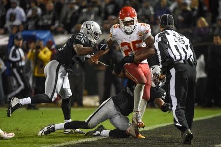 November 20, 2014; Oakland, CA, USA; Kansas City Chiefs running back Jamaal Charles (25) scores a touchdown against Oakland Raiders cornerback D.J. Hayden (25) and defensive back Neiko Thorpe (31) during the fourth quarter at O.co Coliseum. Kyle Terada-USA TODAY Sports