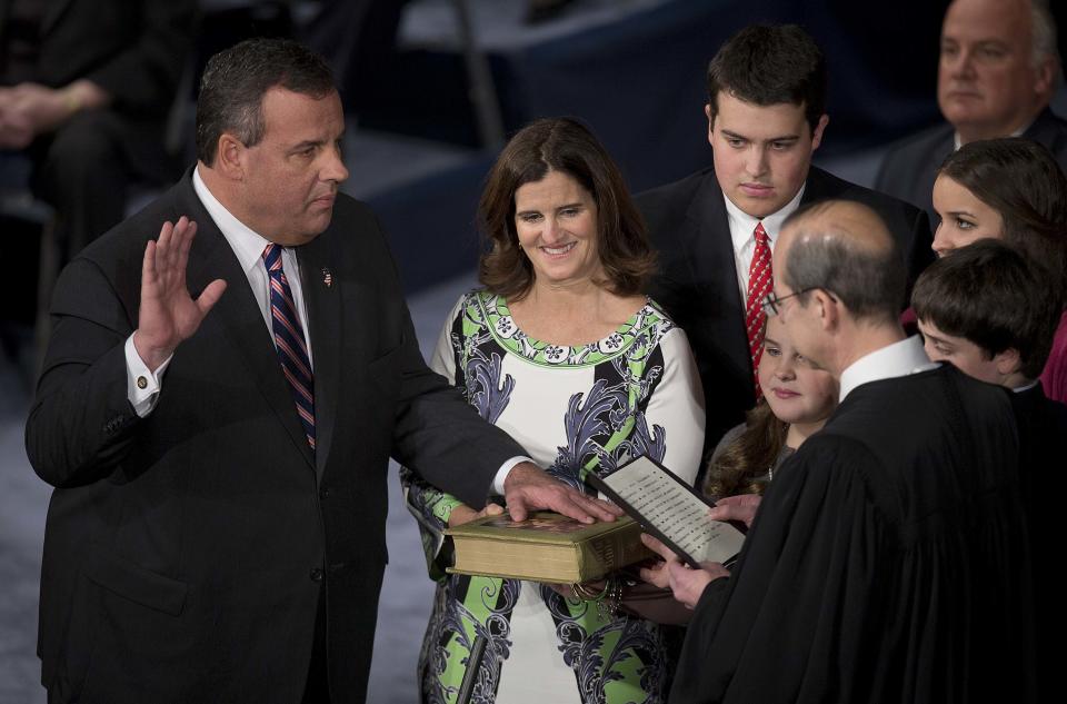 Governor Chris Christie holds his hand aloft as he is sworn in for his second term at the War Memorial Theatre in Trenton, New Jersey January 21, 2014. Christie, a Republican Party star enmeshed in scandal after re-election in November, will return to the themes of small government and bipartisan cooperation when he is sworn in for a second term on Tuesday. (REUTERS/Carlo Allegri)