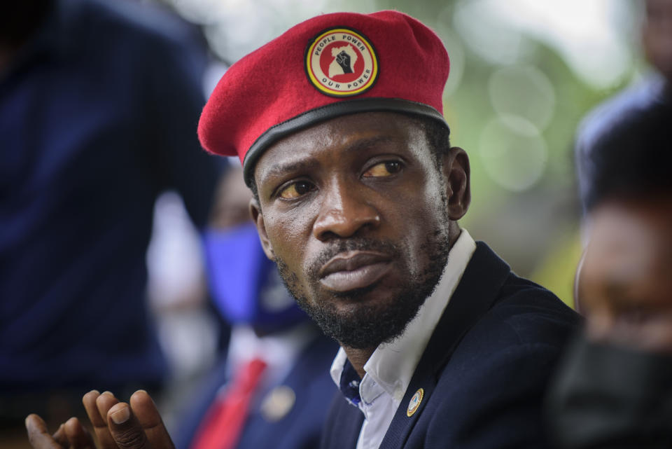 Opposition presidential challenger Bobi Wine, speaks to the media outside his home, in Magere, near Kampala, in Uganda Tuesday, Jan. 26, 2021. An attorney for Bobi Wine says Ugandan soldiers have withdrawn from the opposition presidential challenger’s home the day after a judge ruled that his house arrest was unlawful. But the attorney tells The Associated Press that security forces can still be seen in the village near the candidate’s property outside the capital, Kampala. (AP Photo/Nicholas Bamulanzeki)