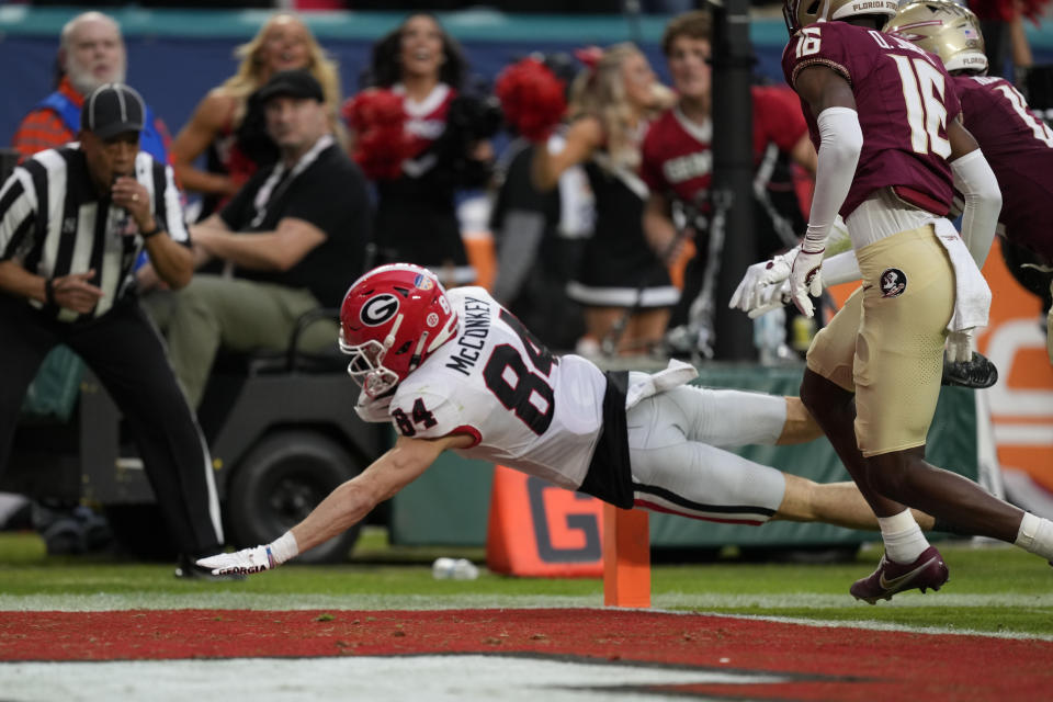 Georgia wide receiver Ladd McConkey (84) dives for a touchdown past Florida State defensive back Quindarrius Jones (16) in the first half of the Orange Bowl NCAA college football game, Saturday, Dec. 30, 2023, in Miami Gardens, Fla. (AP Photo/Rebecca Blackwell)